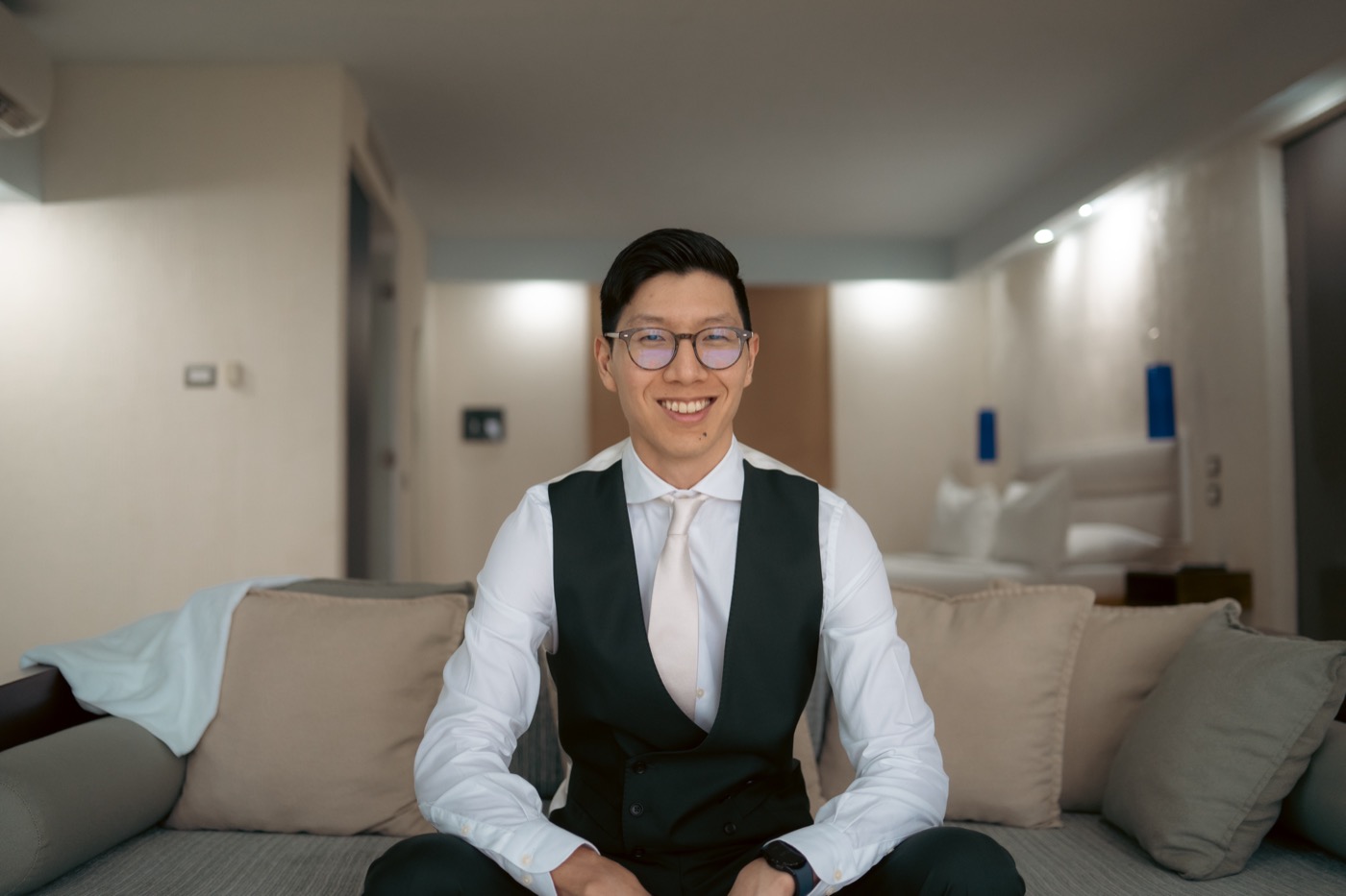 Jeong Park, fractional COO, smiling, in a white shirt and dark vest